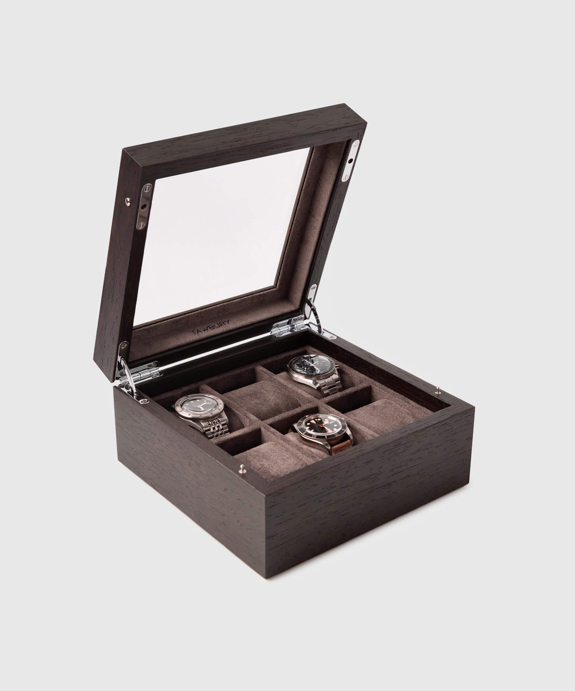 A TAWBURY Grove 6 Slot Watch Box with Glass Lid - Kassod displaying four timepieces.