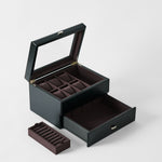 The TAWBURY Bayswater 6 Watch Jewelry Box in Midnight Black features a glass lid, multiple compartments, a large drawer, and comes with a removable ring tray.