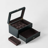 The TAWBURY Bayswater 6 Watch Jewelry Box in Midnight Black features a glass lid, multiple compartments, a large drawer, and comes with a removable ring tray.