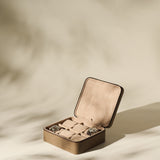 The TAWBURY Fraser 6 Watch Case in taupe leather holds up to six watches, shown on a neutral background with soft shadows.