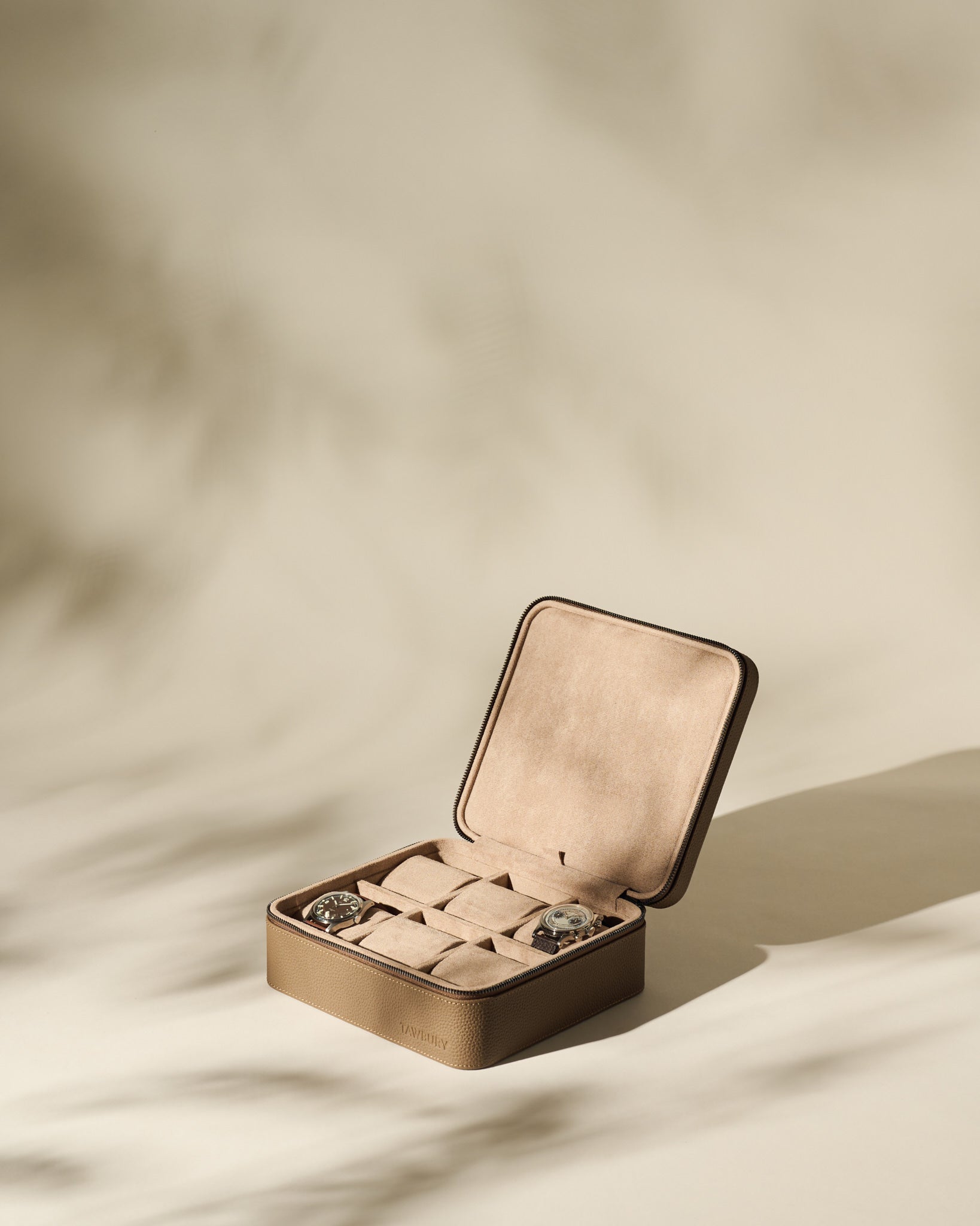 The TAWBURY Fraser 6 Watch Case in taupe leather holds up to six watches, shown on a neutral background with soft shadows.