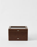 The TAWBURY Bayswater 6 Watch Jewelry Box in brown features a glass top and two metal-handled drawers, offering elegant watch storage. Shown here against a plain white background.