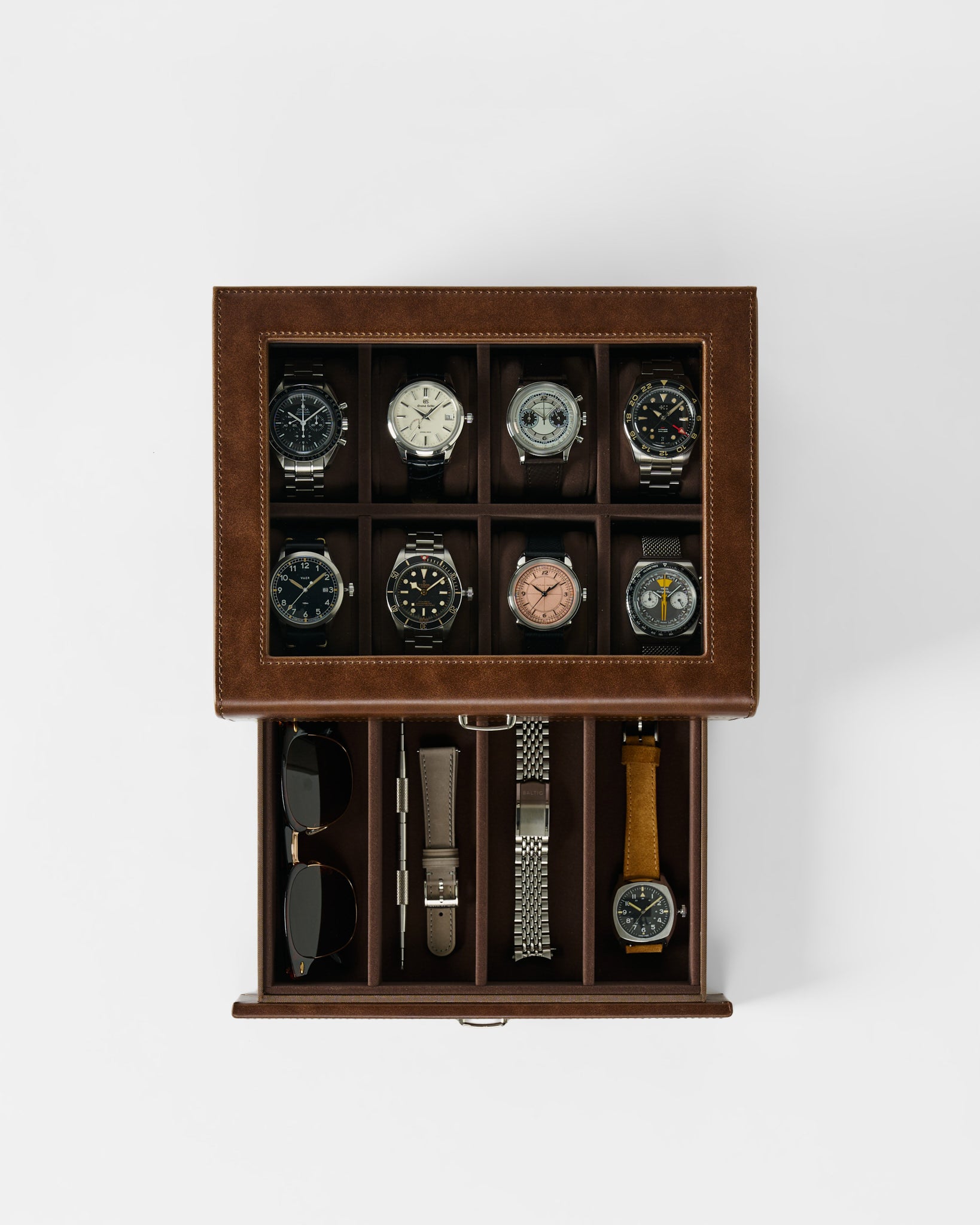 The TAWBURY Bayswater 8 Slot Watch Box with Storage in brown keeps up to eight watches, plus straps, sunglasses, and accessories neatly organized—a stylish storage solution viewed from above.