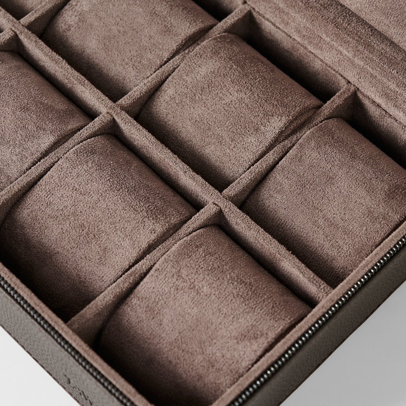 The TAWBURY Fraser 8 Watch Case in brown features a suede-lined interior with multiple padded compartments, perfect for organizing and protecting up to eight watches or other small valuables.