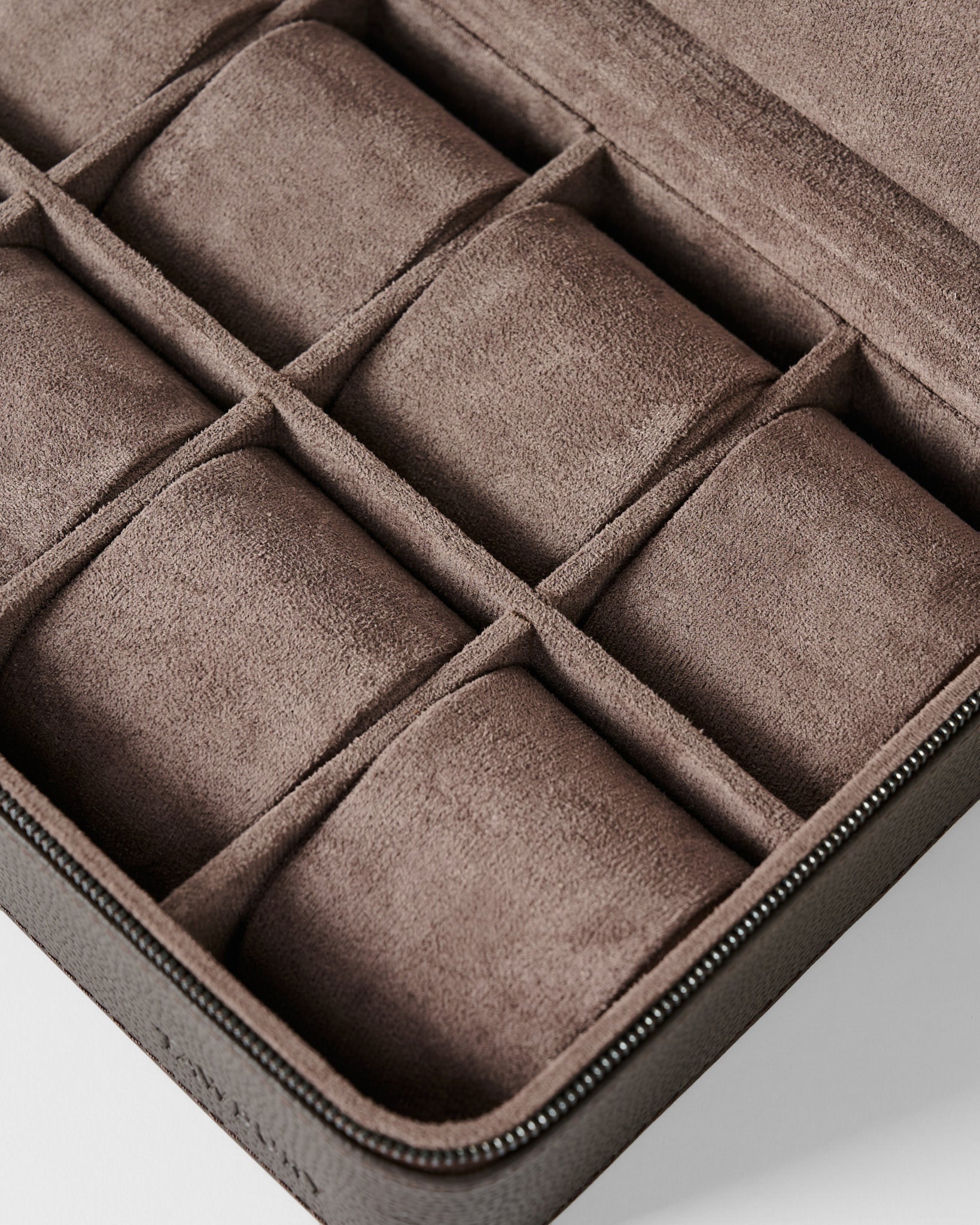 The TAWBURY Fraser 8 Watch Case in brown features a suede-lined interior with multiple padded compartments, perfect for organizing and protecting up to eight watches or other small valuables.