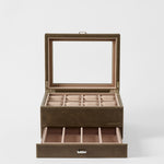 The TAWBURY Bayswater 8 Slot Watch Box with Storage in Driftwood Taupe features a glass lid, eight watch compartments, and a pull-out drawer for extra storage—perfect for keeping your collection organized and elegant.
