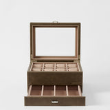 The TAWBURY Bayswater 8 Slot Watch Box with Storage in Driftwood Taupe features a glass lid, eight watch compartments, and a pull-out drawer for extra storage—perfect for keeping your collection organized and elegant.