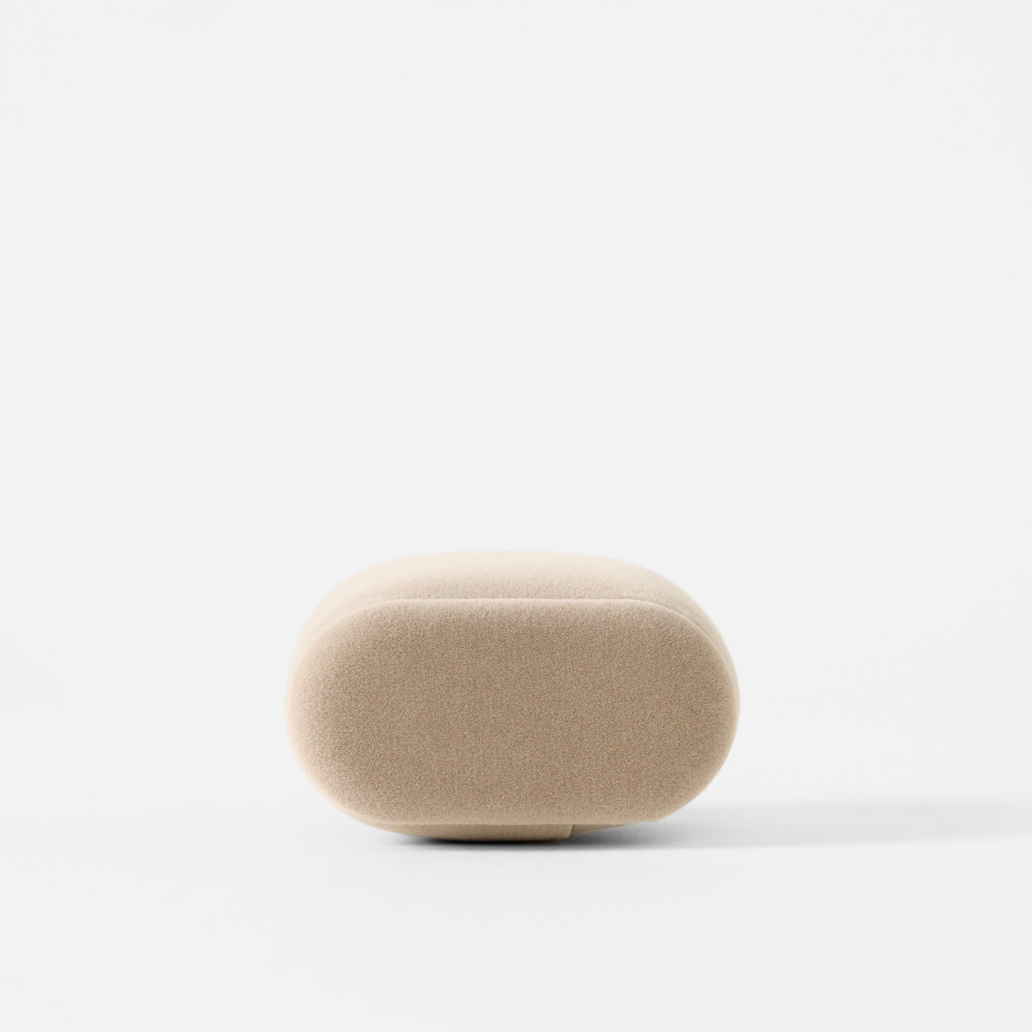 The TAWBURY Bayswater Watch Pillows in beige, small 50mm size, are oval-shaped and upholstered with a smooth surface reminiscent of velveteen, shown against a white background.