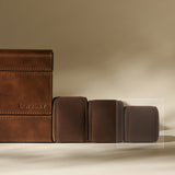 Four TAWBURY Bayswater Watch Pillows in graphite (55mm X-Small) are arranged in a row on a beige surface with a neutral background.