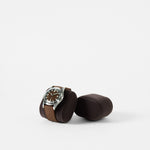 A TAWBURY Bayswater Watch Pillow in charcoal (50mm, X-Small) displays a wristwatch with a brown leather strap, resting beside an identical empty holder on a plain white background.