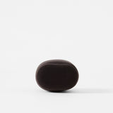 A charcoal, oval-shaped TAWBURY Bayswater Watch Pillow (50mm, X-Small) with a soft, smooth texture is centered against a plain white background.