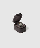 The TAWBURY Fraser 1 Watch Travel Case - Brown (Coming Soon) showcases a wristwatch with a black strap, offering style and protection against a plain light gray background.