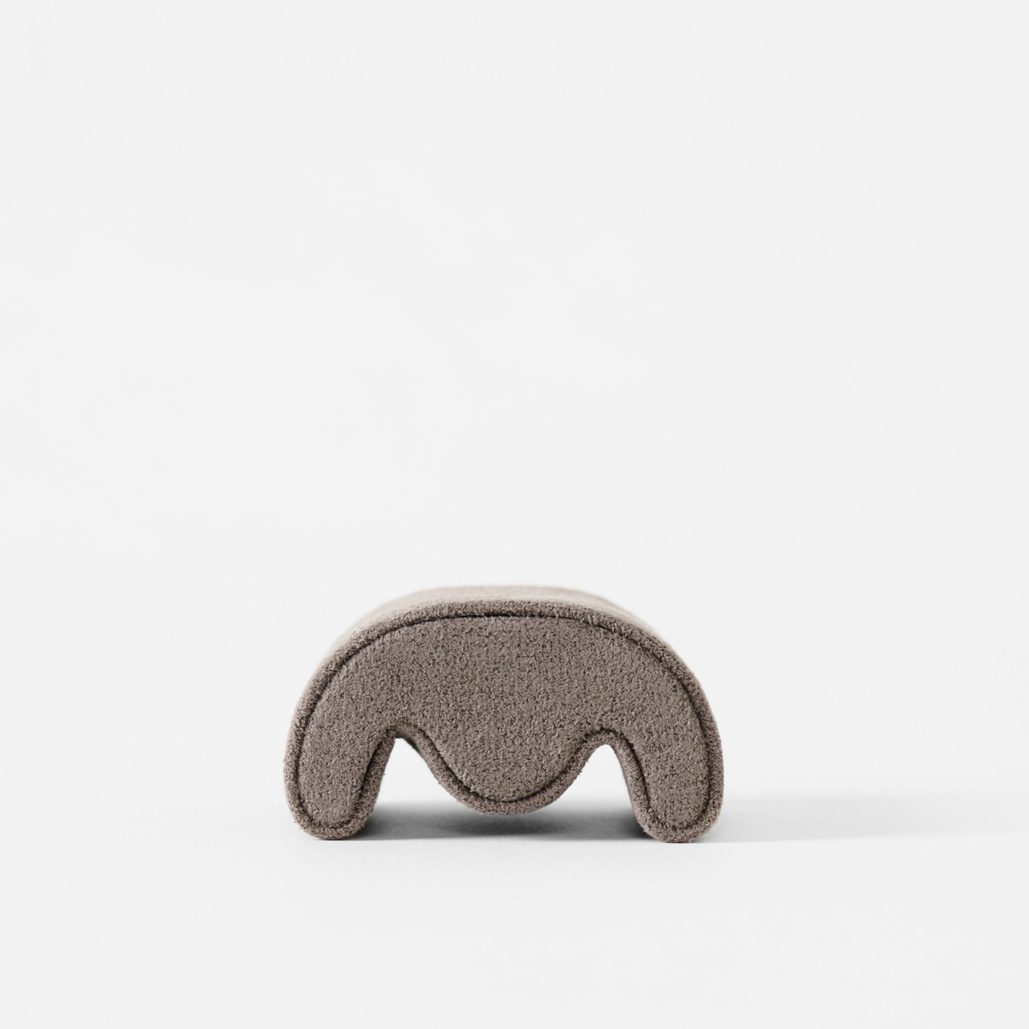 The TAWBURY Grove Watch Pillows - X-Small in brown, designed for slender wristwatches with a curved wave-like cutout, is shown on a plain white background.