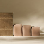 The TAWBURY Bayswater 8 Slot Watch Box with Storage in Driftwood Taupe features elegant faux leather, beige velvet cushions, and refined branding—perfect for stylish watch organization in any setting.
