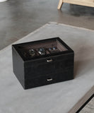 A Tawbury Bayswater 6 Watch Jewellery Box - Black sitting on top of a table.