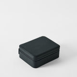 The TAWBURY Fraser 3 Watch Case with Storage in Midnight Black is a closed, textured rectangular box ideal for leather watch storage, displayed on a plain white background.