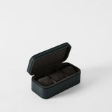 The Fraser 3 Watch Case - Midnight Black by TAWBURY features a hinged, black textured leather exterior and three dark fabric-lined compartments—ideal travel storage for your watch collection.