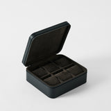 The TAWBURY Fraser 6 Watch Case - Midnight Black features a hinged lid, textured leather exterior, and six soft-lined compartments—offering an elegant solution for organizing your watch collection.