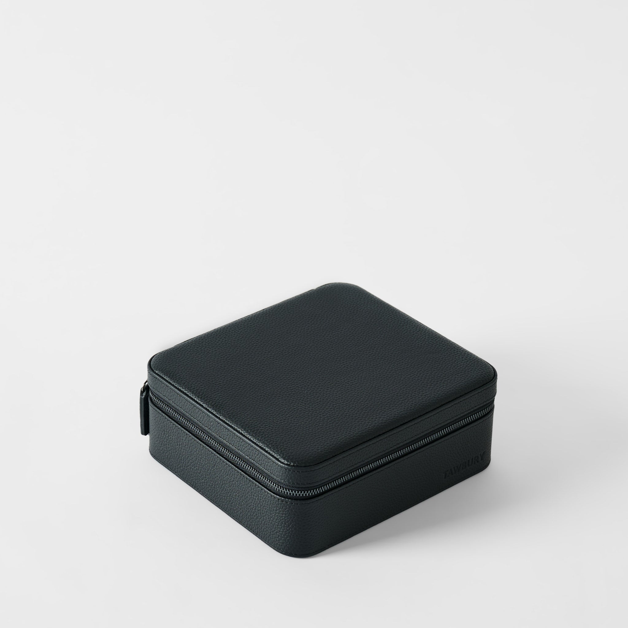 The TAWBURY Fraser 6 Watch Case - Midnight Black is a closed, square leather case with a textured surface and zipper, perfect for storing watches. Photographed on a plain white background.