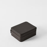 The TAWBURY Fraser 3 Watch Case with Storage in Espresso Brown is a closed, rectangular leather case with a zipper—ideal for secure travel watch storage on any trip.