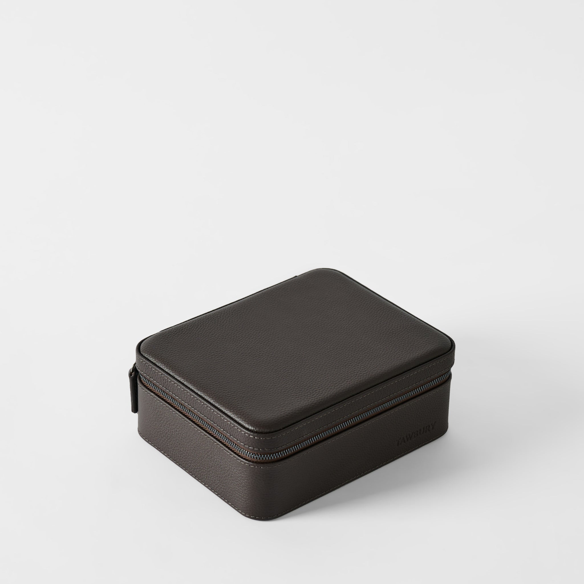 The TAWBURY Fraser 3 Watch Case with Storage in Espresso Brown is a closed, rectangular leather case with a zipper—ideal for secure travel watch storage on any trip.