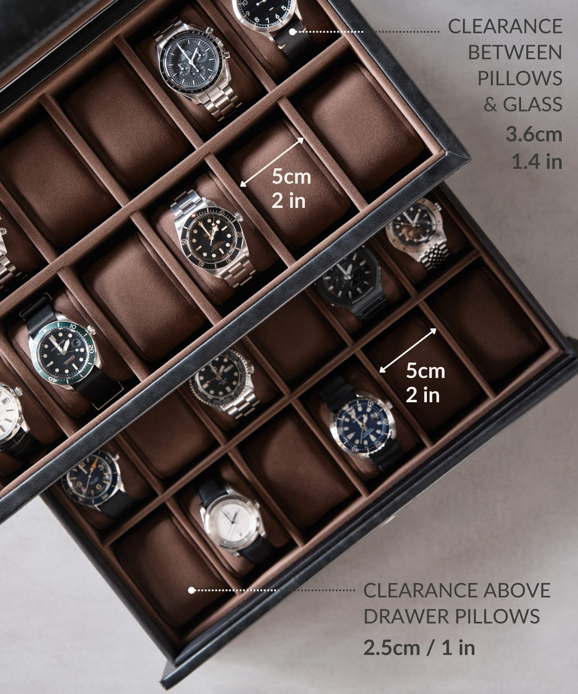 An organized Bayswater 24 Slot Watch Box with Drawer - Black by TAWBURY filled with several timepieces.