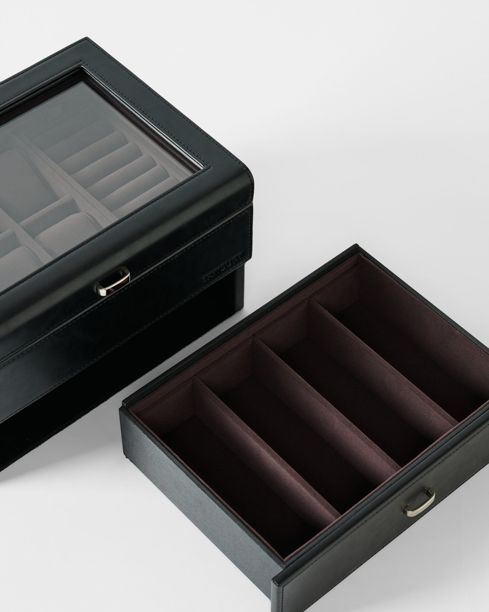 The TAWBURY Bayswater 6 Watch Jewelry Box in Black/Charcoal, made of vegan leather, features a glass lid, removable tray, and multiple compartments. Shown on a white background.