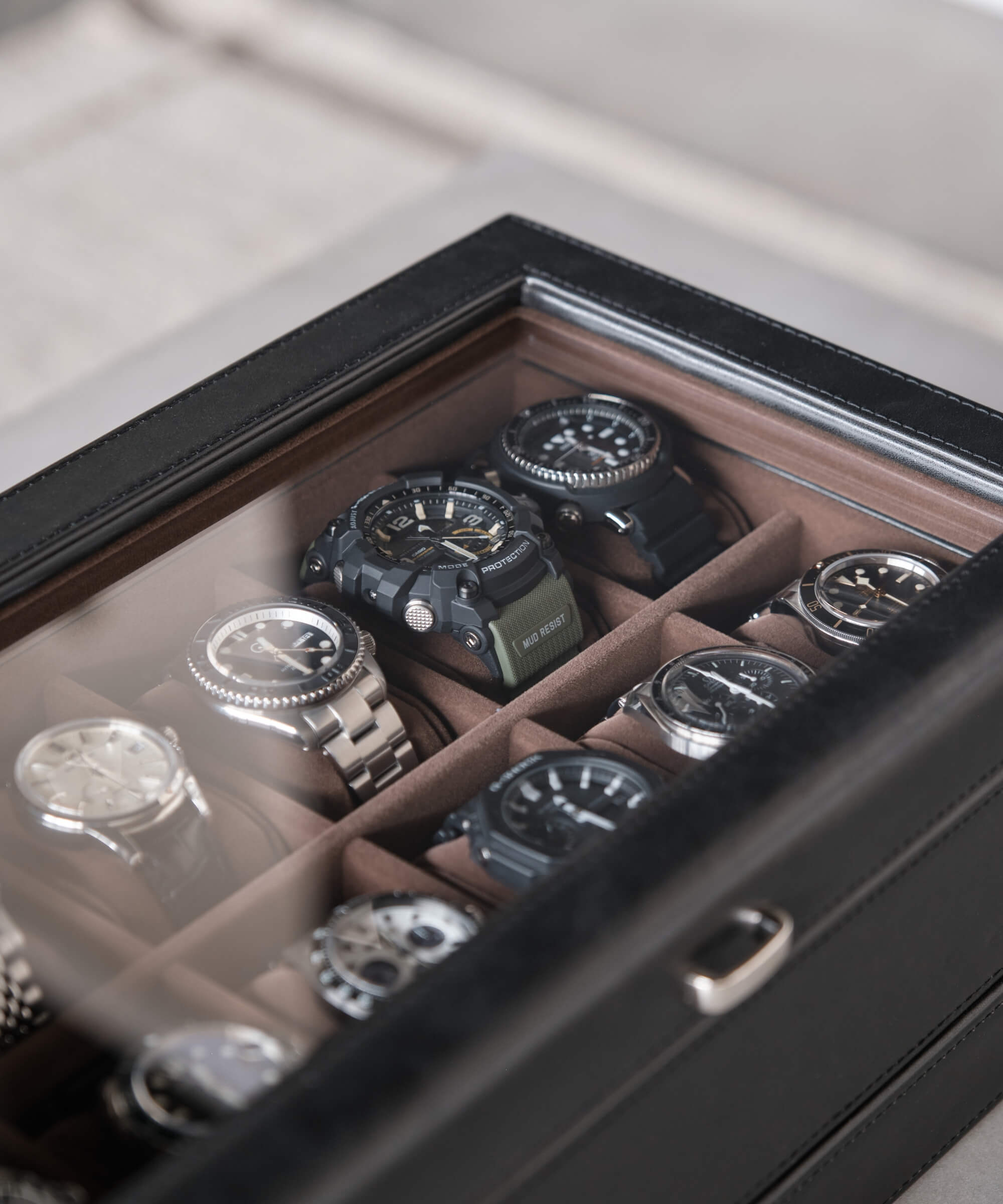 The TAWBURY Bayswater 24 Slot Watch Box with Drawer - Black is a sleek black watch case designed to organise and protect several watches.