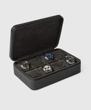 TAWBURY's Fraser 8 Watch Travel Case - Black elegantly organizes four watches: one with a black strap, another with a blue face, plus crisp white and classic black-faced designs—perfect for watch storage.