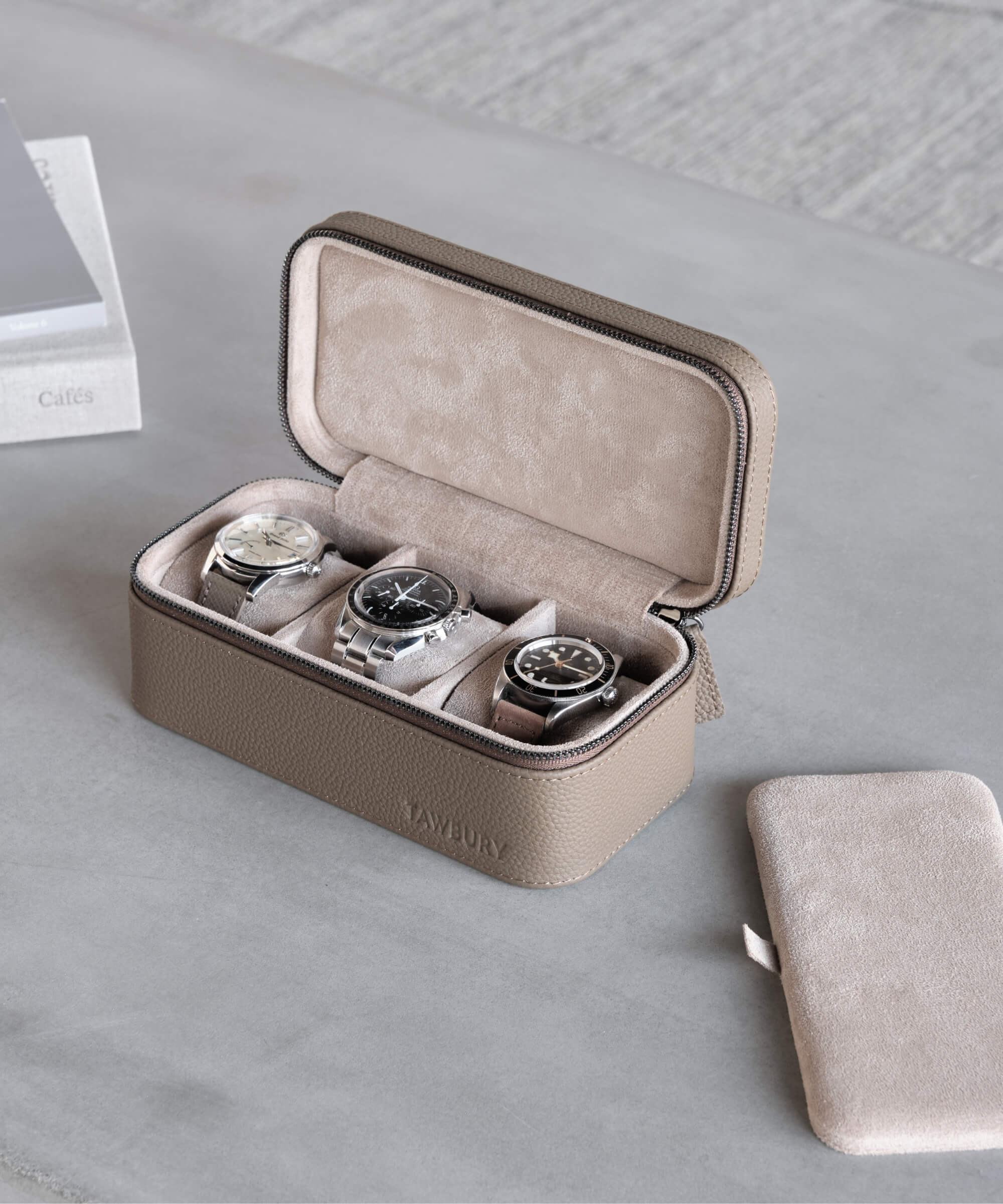 A TAWBURY Fraser 3 Watch Travel Case - Taupe with four watches in it.