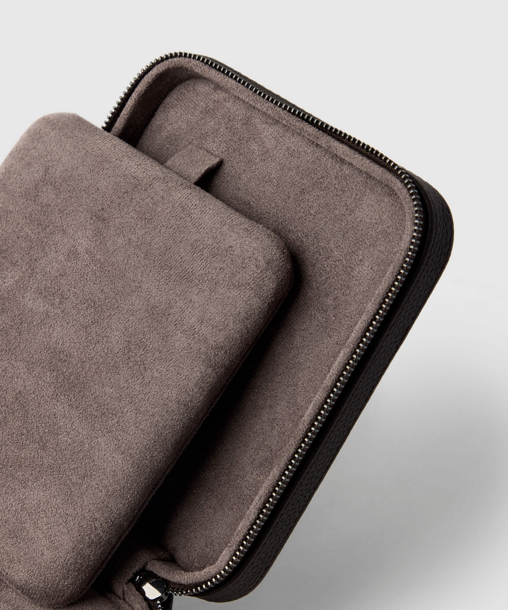 An open zippered suede pouch from the TAWBURY range reveals a soft interior pocket with a small tab, reminiscent of the craftsmanship found in a Fraser 4 Watch Travel Case - Brown (Coming Soon).