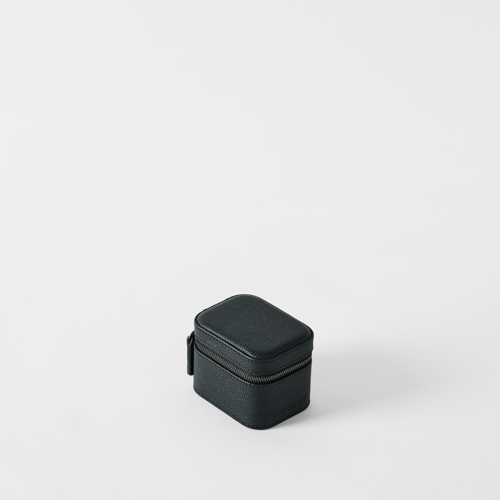 The TAWBURY Fraser 1 Watch Case in Midnight Black, crafted from textured leather, is a compact, rectangular case set against a white background—ideal for storing your watch while traveling.