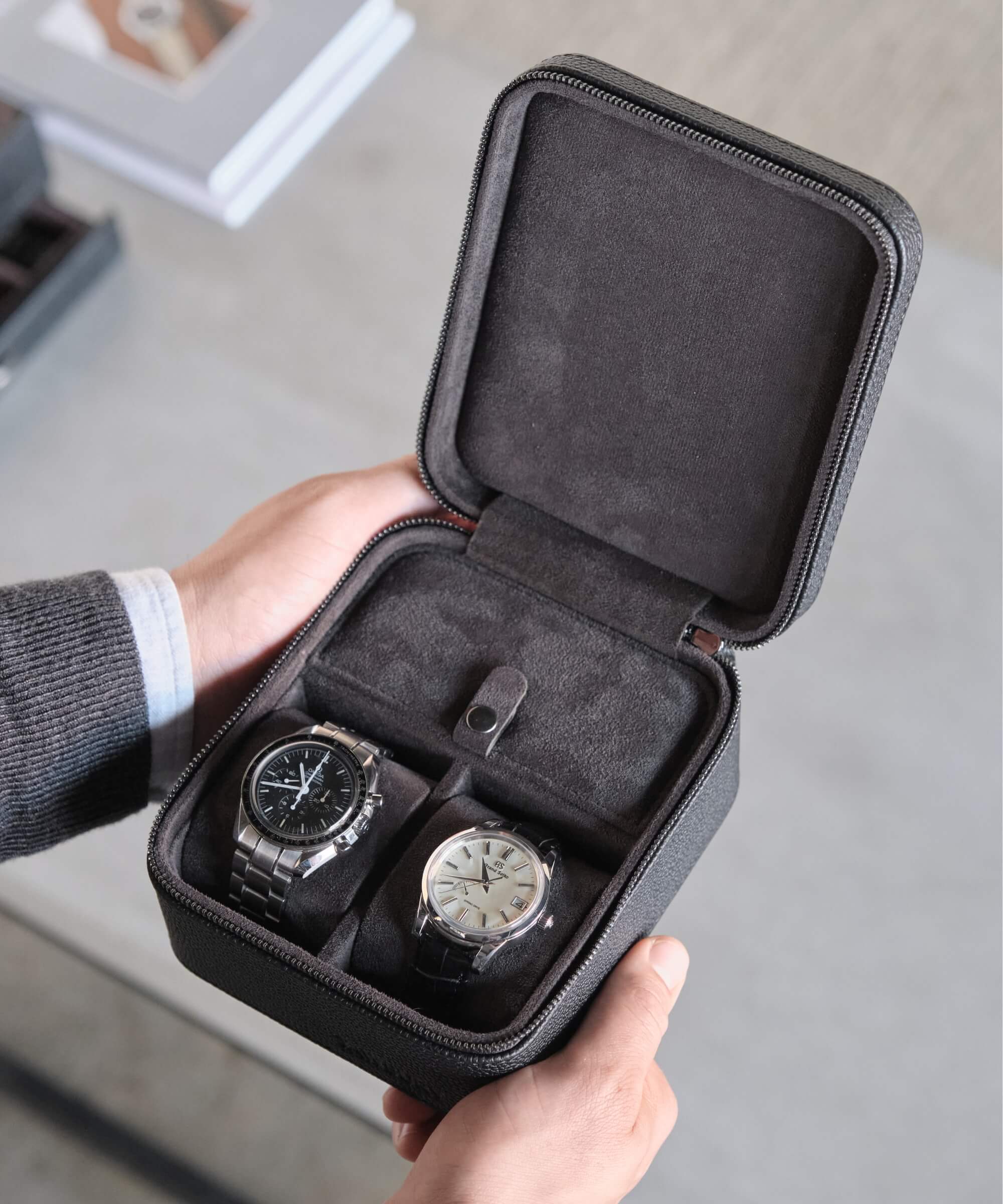 A TAWBURY watch lover showcasing three Fraser 2 Watch Travel Cases with Storage - Black in a leather travel case.