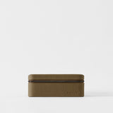 The TAWBURY Fraser 6 Watch Case in Truffle Taupe features a rectangular textured leather design with a zipper, shown closed against a plain white background.