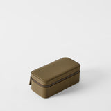 The TAWBURY Fraser 3 Watch Case in Truffle Taupe, featuring a rectangular zippered design and textured finish, is displayed on a plain white surface.