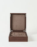 The TAWBURY Grove 12 Slot Wooden Watch Box in dark walnut features a solid lid and multiple padded compartments for organizing watches, shown against a plain white background.
