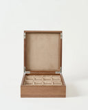 The TAWBURY Grove 12 Slot Wooden Watch Box in light walnut wood has a solid lid and beige velvet-lined square compartments for your watches.