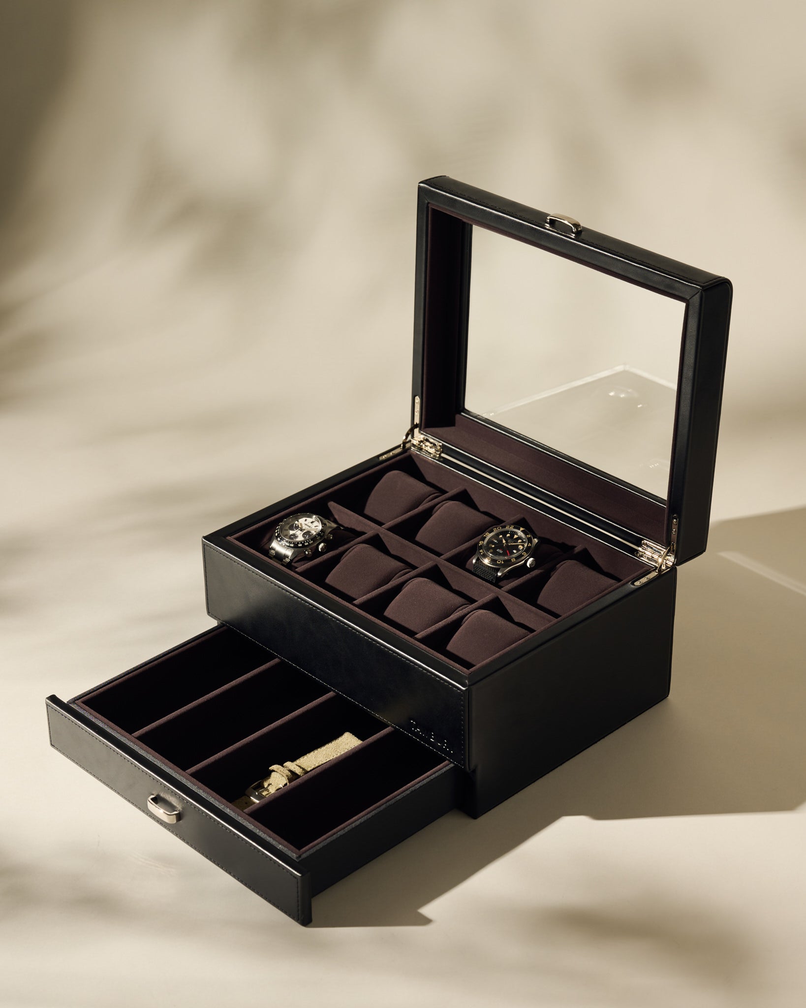 The TAWBURY Bayswater 8 Slot Watch Box in Black/Charcoal features a glass lid to display watches and an open drawer below for extra storage and compartments.