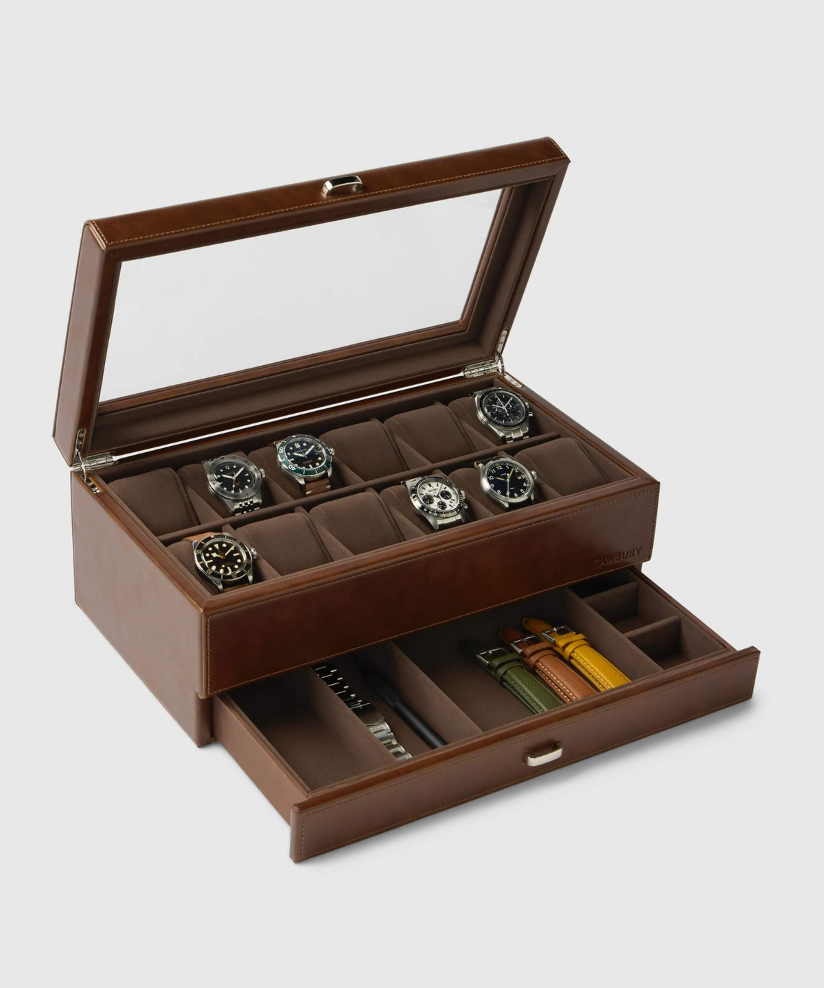 The Bayswater 12 Slot Watch Box with Storage from TAWBURY is an elegant brown display crafted from vegan leather, featuring a scratch-free interior and an open lid showcasing up to six watches. It also includes a convenient drawer below for storing watch straps and tools.