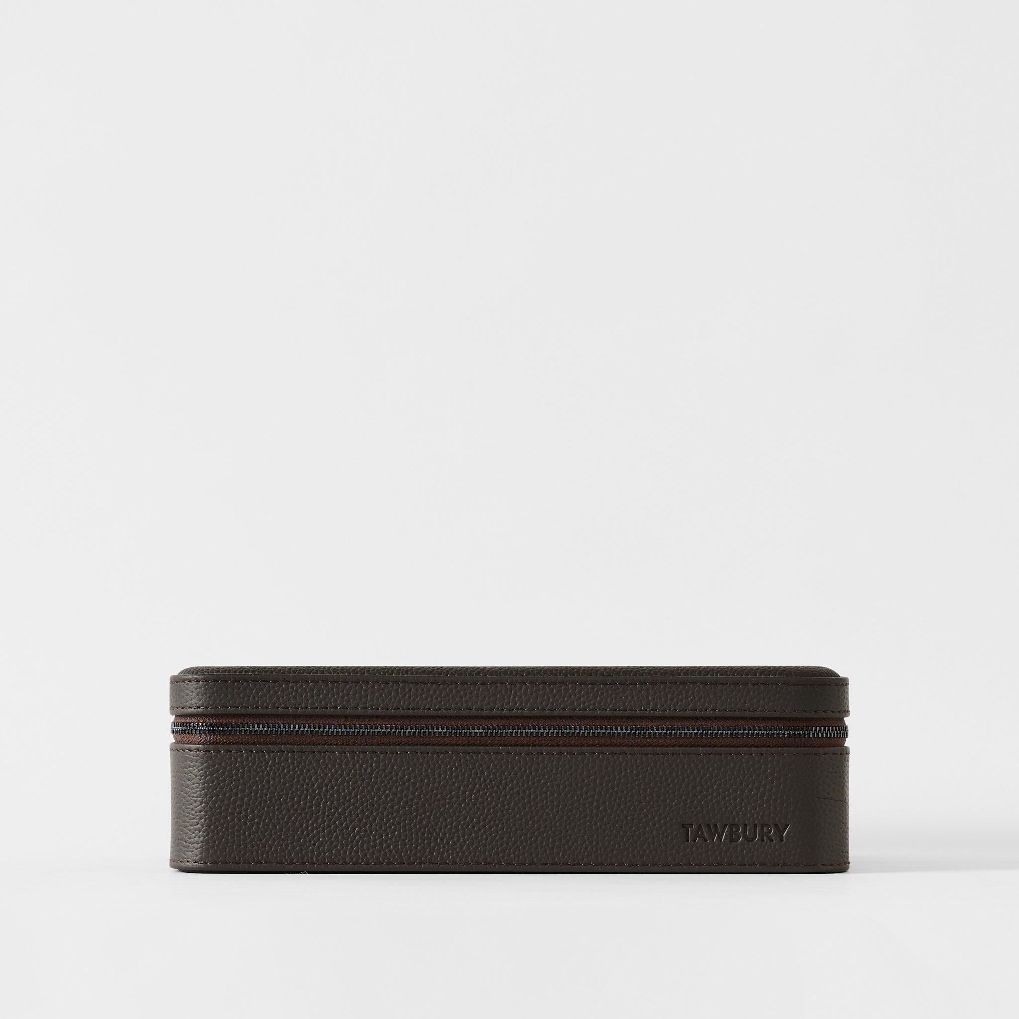 The Fraser 8 Watch Case by TAWBURY, in espresso brown leather with a zipper, sits on a plain white background and features "TAWBURY" embossed on the lower right corner.