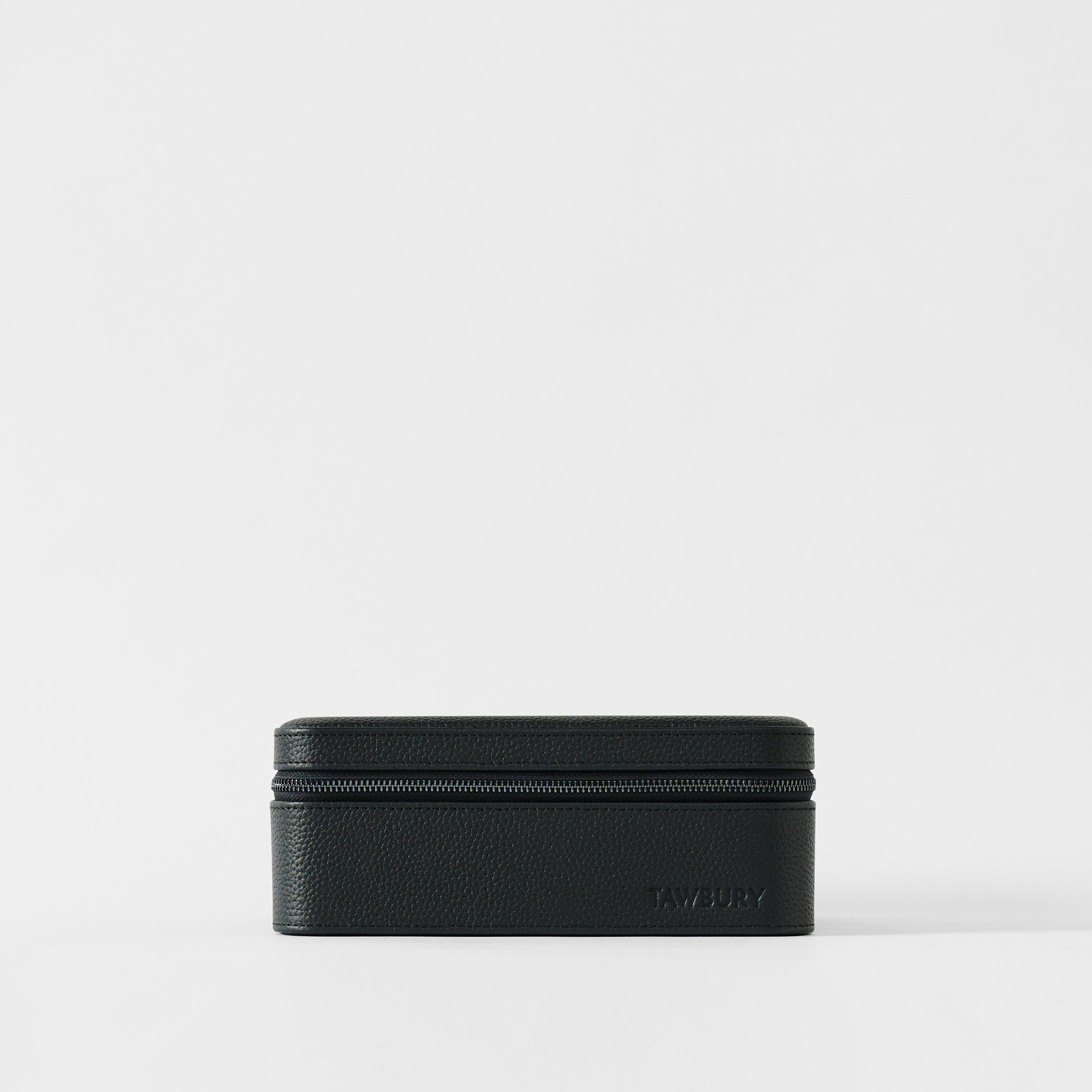 A rectangular black leather Fraser 3 Watch Case by TAWBURY rests on a white background, with "TAWBURY" embossed in the lower right corner—an elegant choice for travel watch storage.