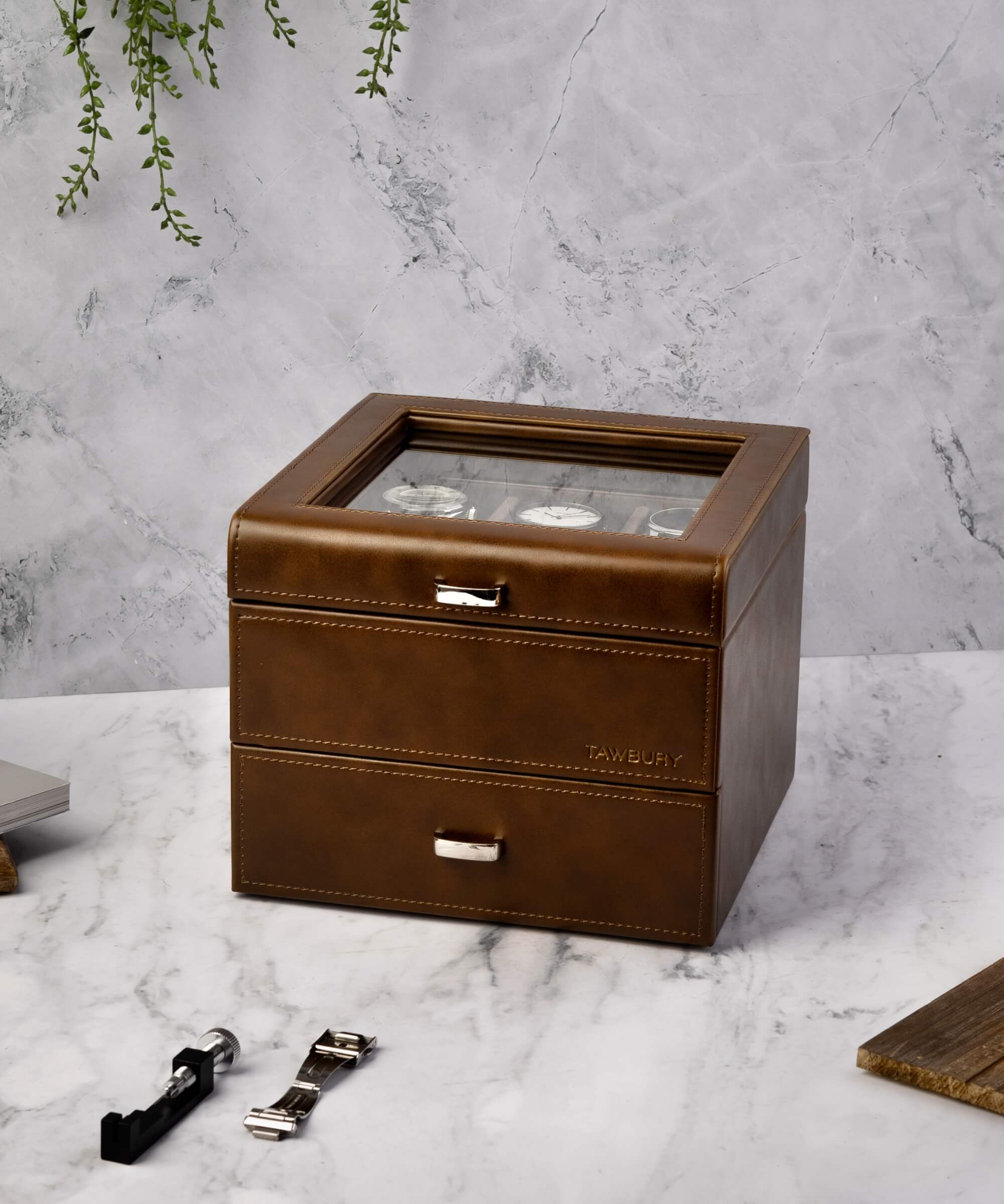 A TAWBURY Bayswater 3 Watch Jewellery Box - Brown, crafted with brown leather, elegantly placed on a marble table.