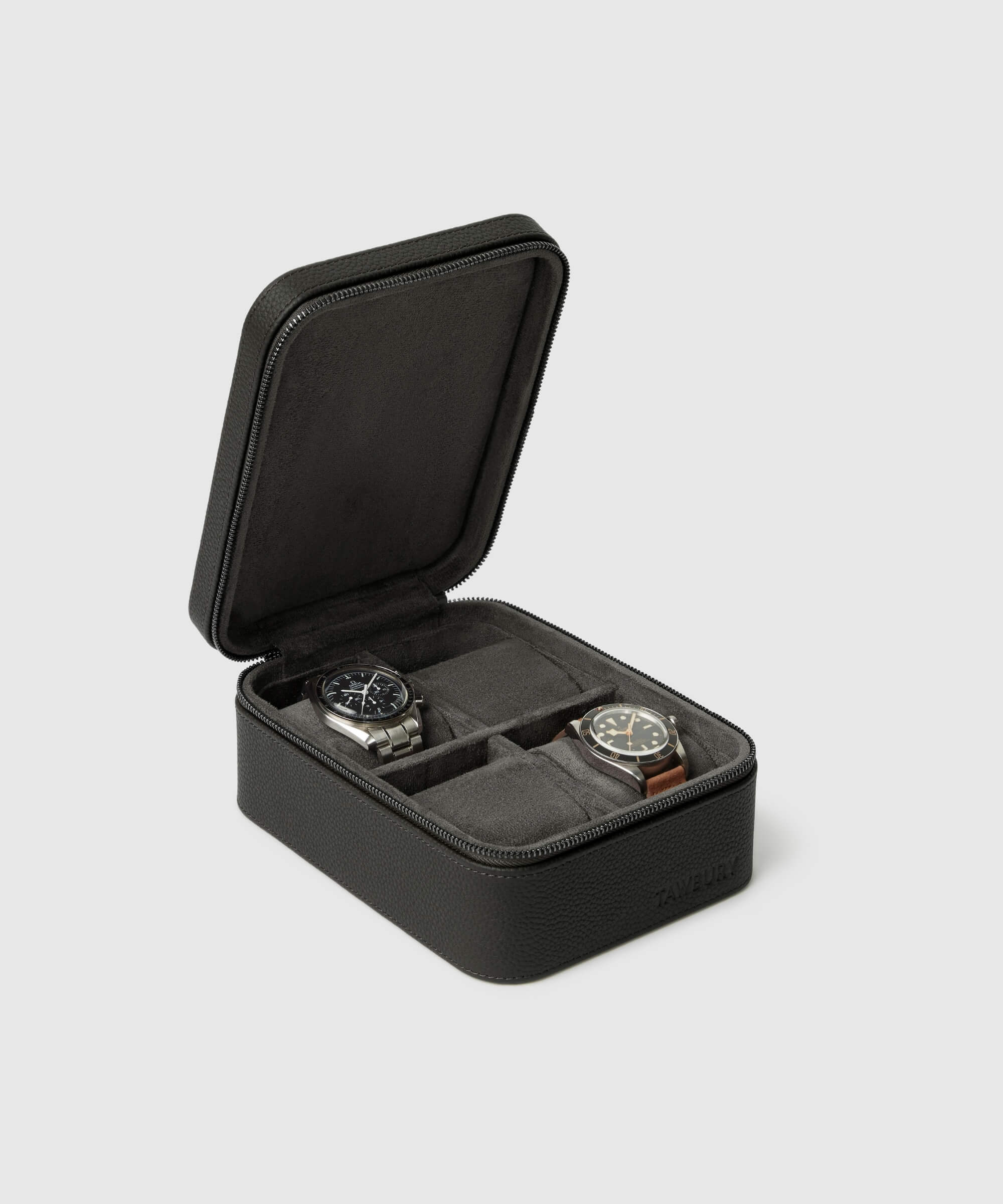 A black rectangular leather watch case with a zip closure is open to reveal two wristwatches from the Fraser 4 Watch Travel Case - Black (Coming Soon) by TAWBURY, each in separate compartments - an ideal choice for stylish and secure watch storage.