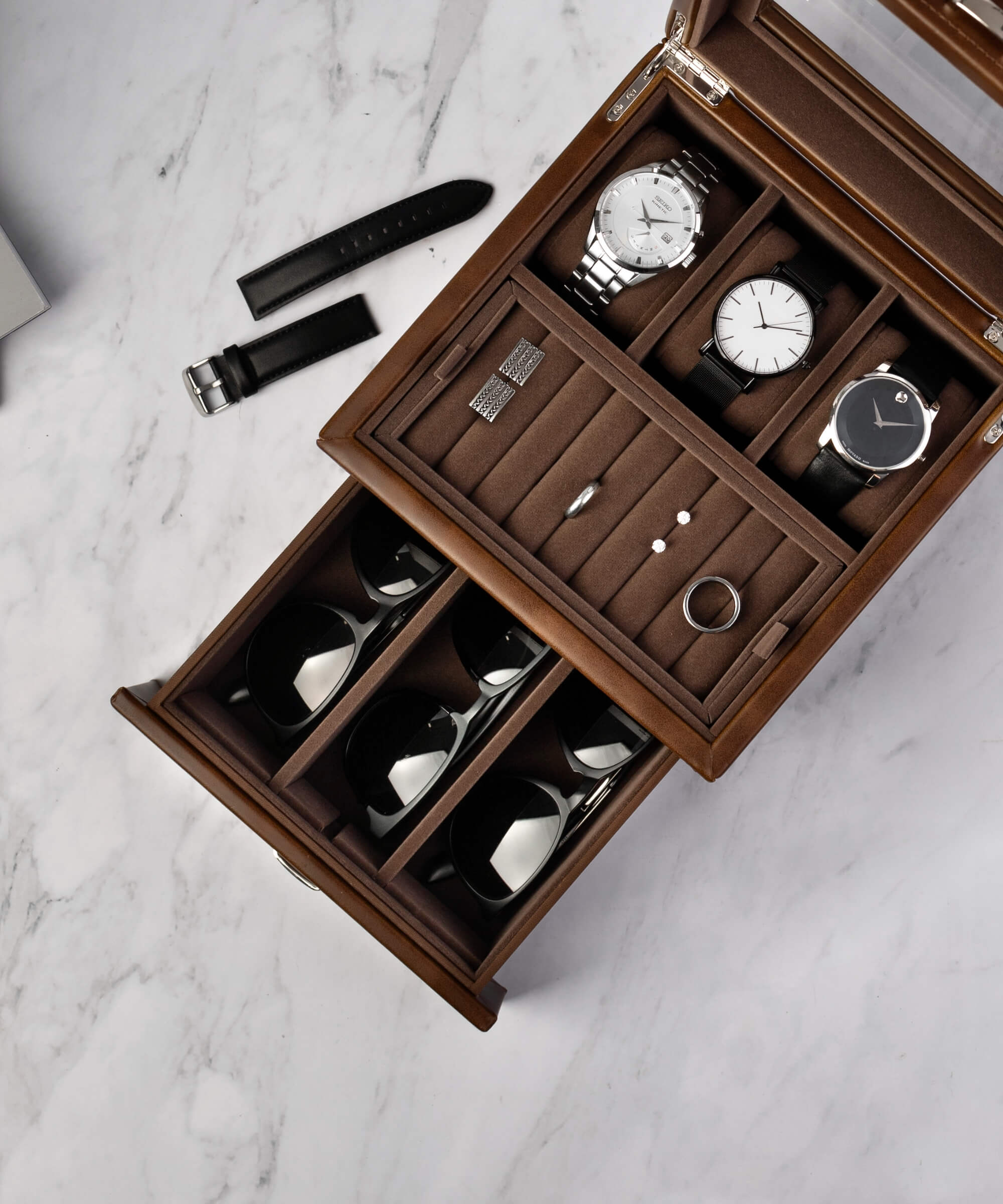 A TAWBURY Bayswater 3 Watch Jewellery Box - Brown with timepieces and lifestyle accessories inside.