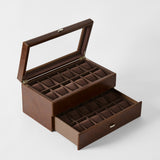 The TAWBURY Bayswater 24 Slot Watch Box with Drawer in Chestnut Brown features a glass lid, watch pillows, multiple compartments for secure storage, and a bottom drawer for extra organization, shown on a plain background.