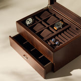 The TAWBURY Bayswater 6 Watch Jewelry Box in brown is shown with its lid open, displaying two wristwatches, two pairs of cufflinks, empty compartments, and a partially open lower drawer.
