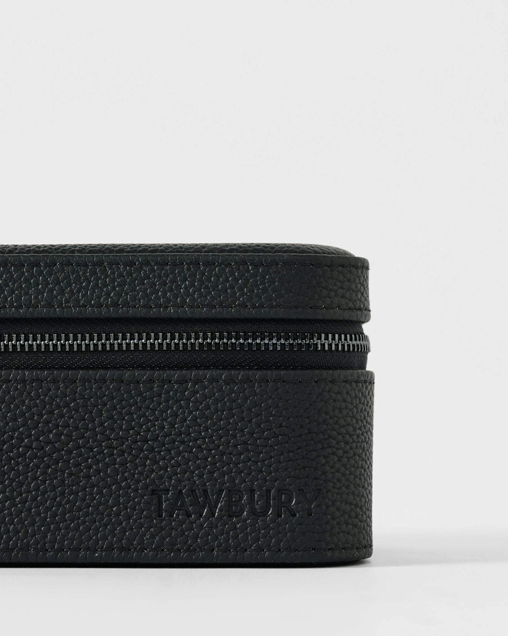 Close-up of the TAWBURY Fraser 2 Watch Case - Black, featuring textured leather and embossed branding, designed as a secure and stylish dual watch travel case.