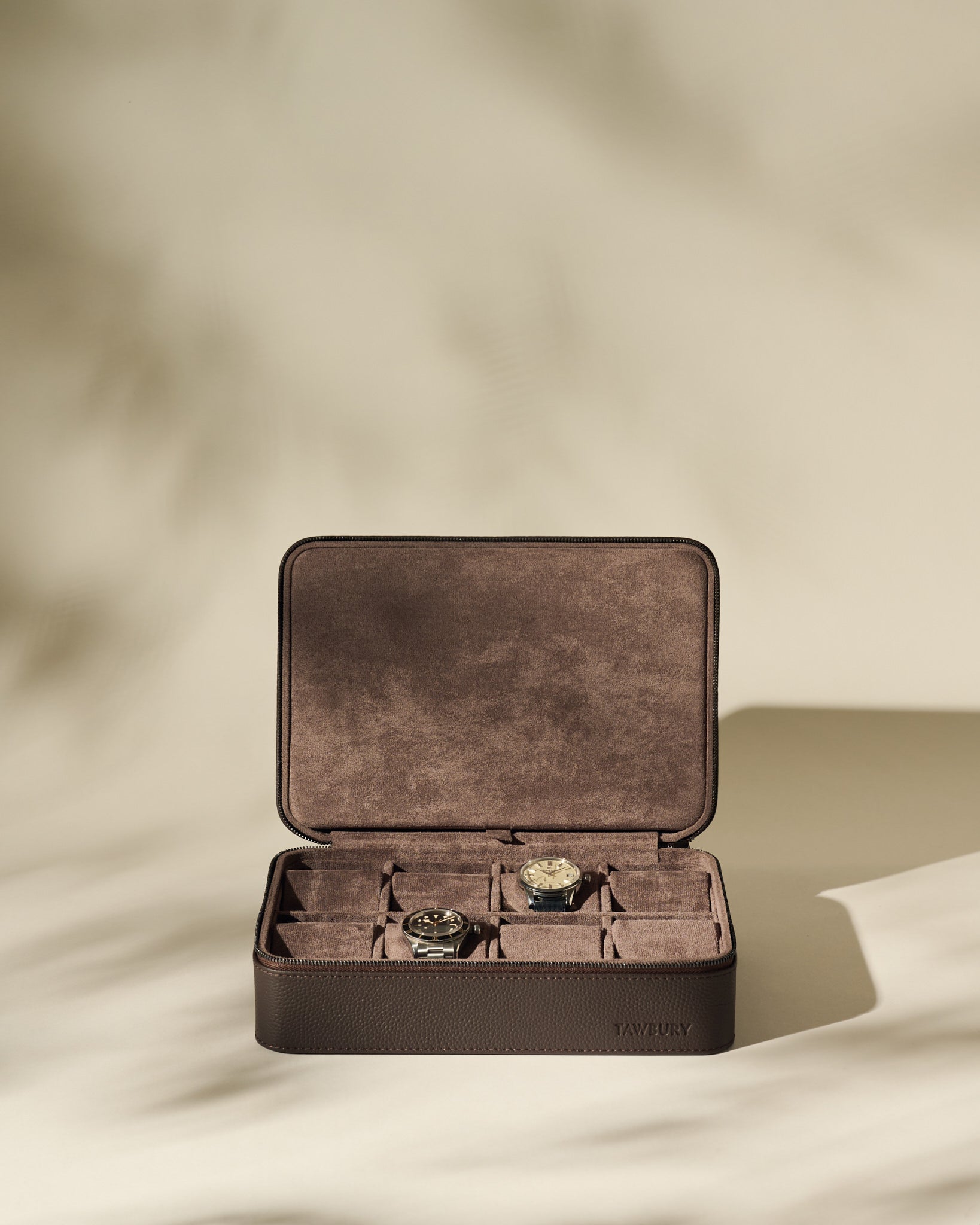 The TAWBURY Fraser 8 Watch Case in brown features a suede interior, stores up to eight watches, and is displayed open against a neutral background.
