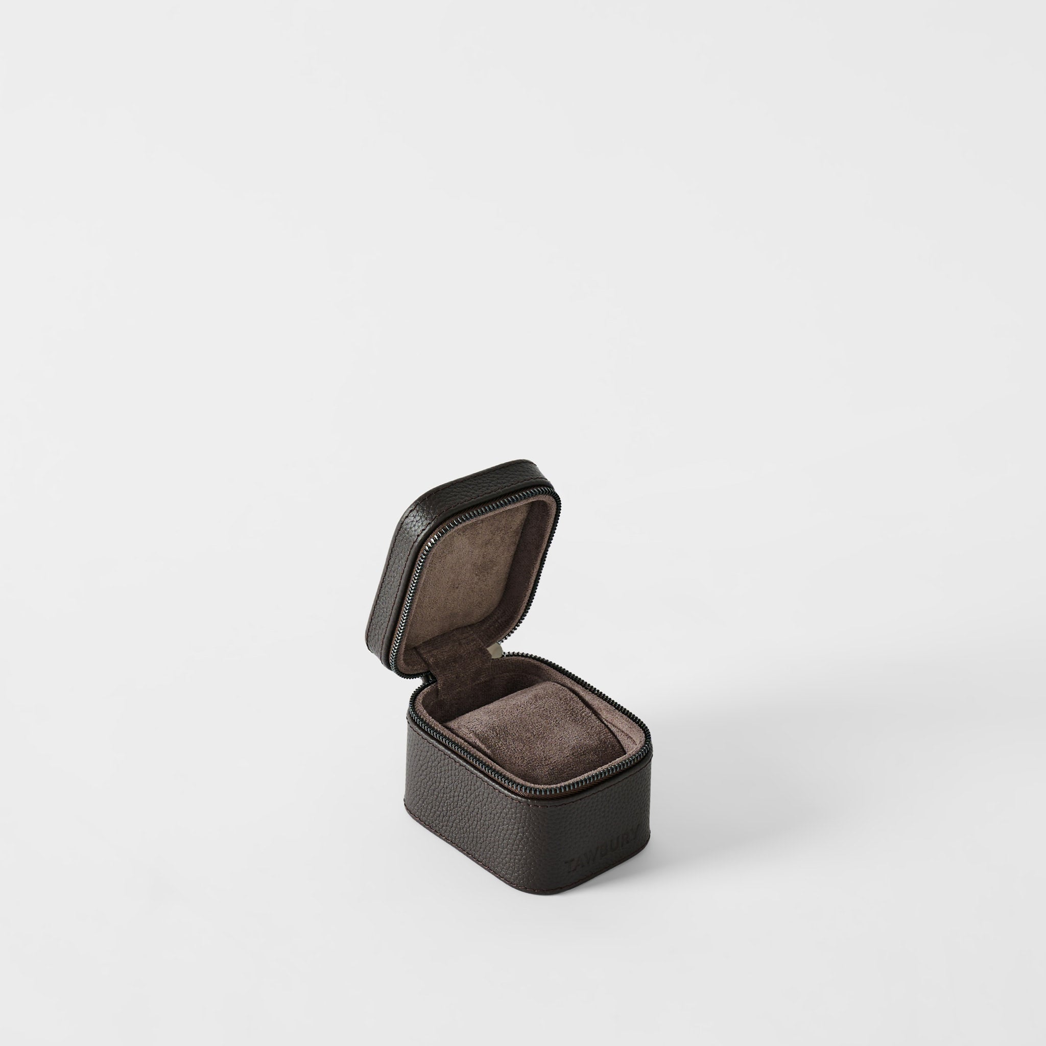The TAWBURY Fraser 1 Watch Case in Espresso Brown features a textured exterior, hinged lid, and soft suede-like interior—perfect as a compact jewelry or leather watch box.