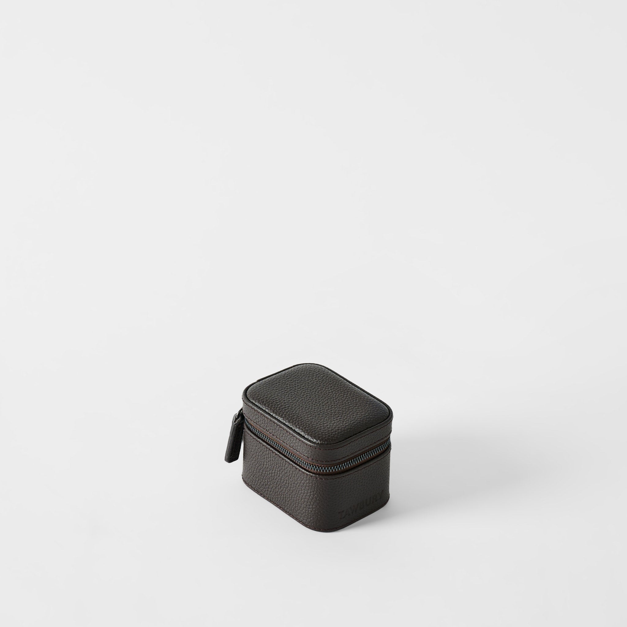 The TAWBURY Fraser 1 Watch Case in espresso brown textured leather features a compact rectangular design with a zipper, shown on a plain white background.